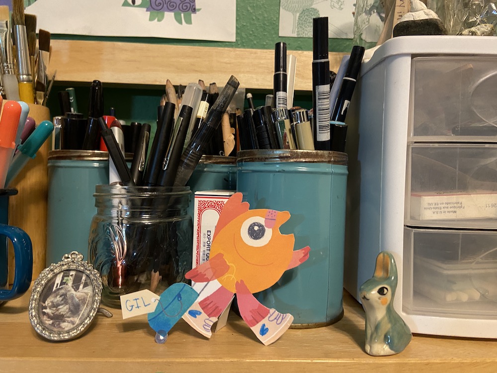 Studio shelf with fish walking with suitcase