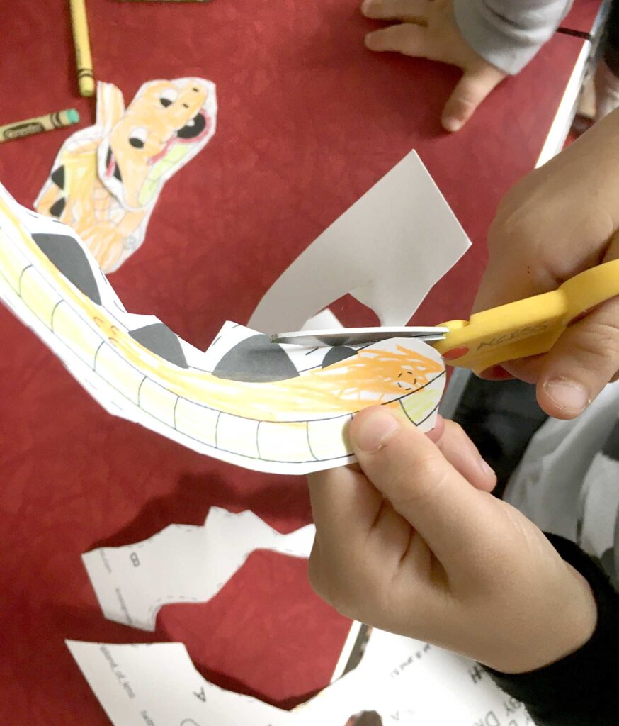 Cutting out colored baby dragon tail